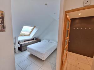 a small bedroom with a bed and a window at Bel appartement T2 avec balcon, WIFI et parking près de la plage - FR-1-706-2 in Châtelaillon-Plage