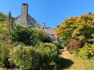 a garden with a house in the background at Worthy Manor in Porlock