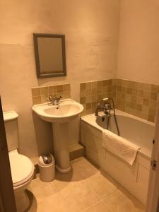 a bathroom with a sink and a toilet and a tub at Worthy Manor in Porlock +15 photos