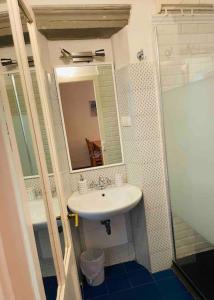 a bathroom with a sink and a mirror at Appartamento Alessia (SMN) in Florence