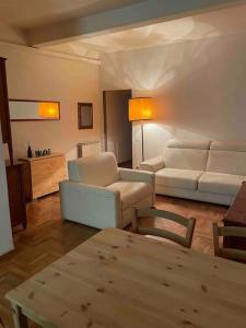 a living room with two white couches and a table at Appartamento Alessia (SMN) in Florence