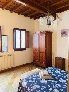 a bedroom with a bed and a wooden cabinet at Appartamento Alessia (SMN) in Florence