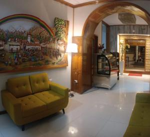 a living room with a couch and a fireplace at Hotel Aural in Cajamarca