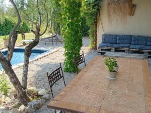 a table and chairs in a yard with a pool at Beautiful villa with private pool in the Luberon in Cucuron