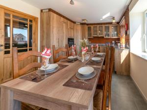 a large wooden table in a kitchen with wooden cabinets at Splendid home near the Spa Francorchamps circuit in Stavelot