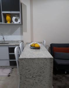 a kitchen with a table with a bowl of bananas on it at Recanto Vovô João in Cunha