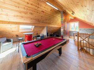 a pool table in a room with a wooden ceiling at Holiday home near the Spa Francorchamps circuit in Stavelot