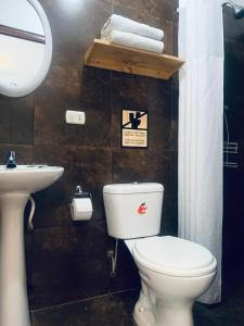 a bathroom with a toilet and a sink at La Tablita in Zorritos