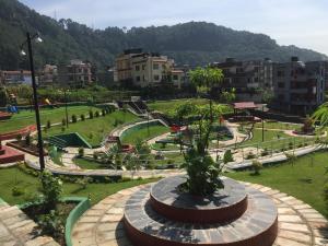 a park with a playground in a city at Raniban Suites - Studio Apartment in Kathmandu