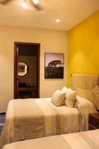 Postel nebo postele na pokoji v ubytování Hotel Boutique Gloriagave