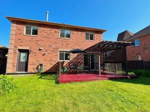 a brick house with a deck in front of it at Barrie Ocean Kingdom in Barrie