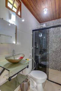 a bathroom with a sink and a toilet and a shower at Pousada Endlessenses in Itacaré