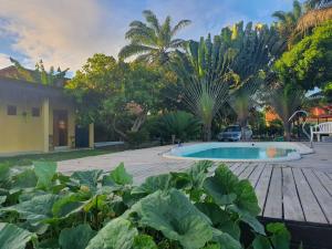 um jardim com piscina e algumas plantas em Sunrise Inn - Pousada Nascer do Sol em Ituberá
