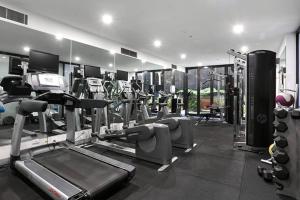 a gym with treadmills and machines in a room at 'The Albert' Where the City meets St Kilda in Melbourne