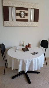 a white table with two chairs in a room at Studio 501 Campinas SP in Campinas +14 photos