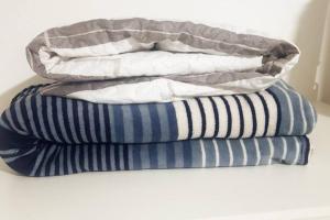 two stacks of pillows sitting on top of each other at Studio 501 Campinas SP in Campinas
