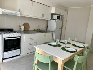 a kitchen with a table with two plates on it at Laguna Pampa in Chascomús