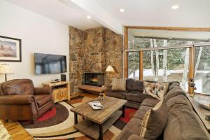 a living room with a couch and a fireplace at Shadowbrook 505 in Snowmass Village