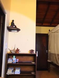 a room with a shelf with a surfboard on the wall at MALLI'S VILLA in Koggala