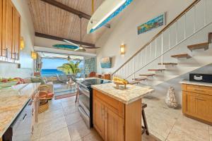 a kitchen with a staircase and a living room at Kulakane 310 in Kahana