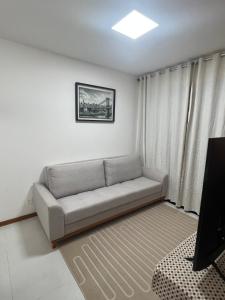 a living room with a couch and a television at Salvador Prime - Caminho das Árvores in Salvador +88 photos