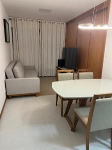 a living room with a white table and chairs at Salvador Prime - Caminho das Árvores in Salvador