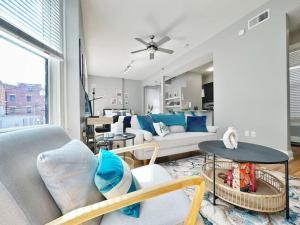a living room with a couch and a table at Boho Studio Loft Meets Luxury in OTR Cincinnati! in Cincinnati