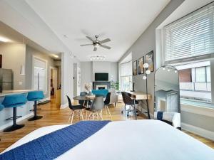 a bedroom with a bed and a kitchen and a dining room at Boho Studio Loft Meets Luxury in OTR Cincinnati! in Cincinnati