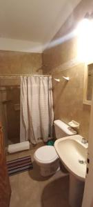 a bathroom with a white toilet and a sink at Departamentos Tilcara in Tilcara