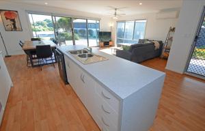 a kitchen and living room with a counter top at Oceans 5 at Middleton - pet friendly WiFi in Middleton