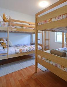 a bedroom with two bunk beds in a room at Oceans 5 at Middleton - pet friendly WiFi in Middleton