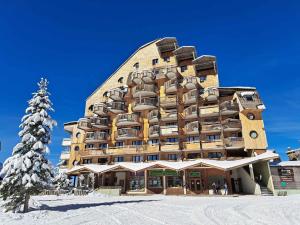 a large building in the snow with a christmas tree at Appartement chalet familial, 8 personnes, 3 balcons, proche pistes et commerces - FR-1-314-120 in Morzine
