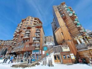 a tall building in the snow in front at Charmant Appartement Rénové de 3 Chambres au Centre d'Avoriaz, Proche des Commerces et Pistes - FR-1-314-116 in Avoriaz