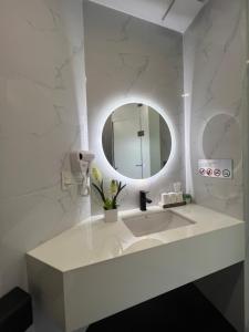 a white bathroom with a sink and a mirror at ANH’s HOUSE in Hue