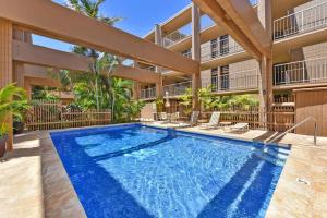 a swimming pool in front of a building at Kaleialoha 213 in Lahaina
