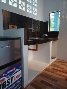 a kitchen with a sink and a counter top at Camp Asgard by Camiguin Viajeros House Rentals in Catarman