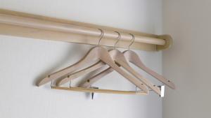 a rack of wooden hangers in a room at Toyoko Inn Osaka Namba in Osaka