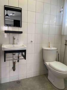 a bathroom with a toilet and a sink at Diamond Bay Homestay in Teluk Intan