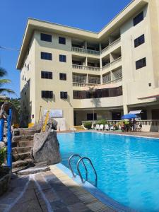 a swimming pool in front of a building at Pangkor Coral Bay Resort(2 bedrooms) in Pangkor