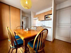 a kitchen with a wooden dining table and chairs at Appartement Flumet, 3 pièces, 6 personnes - FR-1-505-189 in Flumet