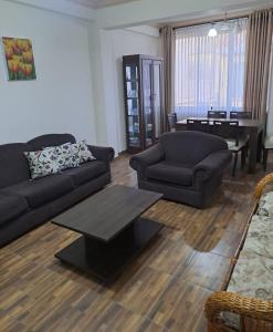 a living room with a couch and a table and a piano at Departamento para 3 personas in Cochabamba