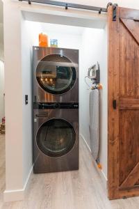 a washer and dryer sitting in a room at BEST of Downtown Indy Luxury Oasis 8BD Entire Home in Indianapolis