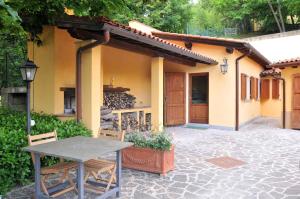 a table and chairs in front of a house at Holiday home in Vicchio - Toskana 27442 in Vicchio