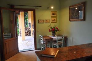 a dining room with a table with a vase of flowers at Holiday home in Vicchio - Toskana 27442 in Vicchio