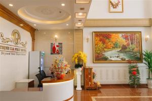 a lobby with a large painting on the wall at Thinh Gia Phat Hotel Hoang Hoa Tham in Ho Chi Minh City