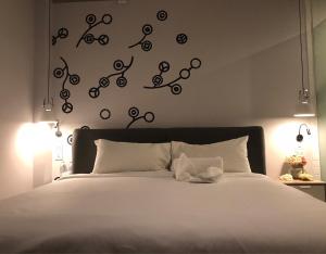 una camera da letto con un letto con lenzuola e luci bianche di Bedspread Hostel a Bangkok