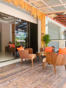 a lobby of a restaurant with chairs and a table at Guest house Helene in Kata Beach
