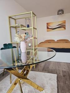 a glass table with a vase on it in a room at SKY HOME in Frankfurt/Main