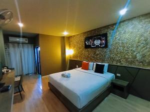 a hotel room with a bed and a table and a desk at The S Design Hotel in Buriram