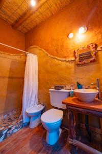 a bathroom with a toilet and a sink at Cabaña Misk'i Nuna, en las afueras de Tilcara in Tilcara